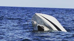 Muskegon, MI, and North Shore firefighters rescued two people who were clinging to the railing as their 20-foot boat sank into Lake Michigan on Monday. Muskegon, MI, and North Shore firefighters rescued two people who were clinging to the railing as their 20-foot boat sank into Lake Michigan on Monday.