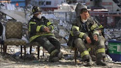 Firefighters rest during the cleanup operation at the World Trade Center in New York City after the towers were demolished by a terrorist attack on Sept. 11, 2001.