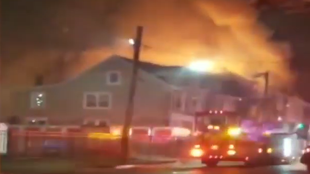 Firefighters battled a three-alarm blaze Tuesday that erupted at a vacant duplex in Trenton described as a 'hoarder' house by fire officials.