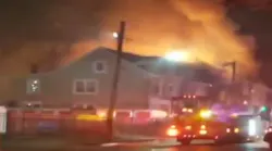 Firefighters battled a three-alarm blaze Tuesday that erupted at a vacant duplex in Trenton described as a 'hoarder' house by fire officials.