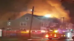 Firefighters battled a three-alarm blaze Tuesday that erupted at a vacant duplex in Trenton described as a 'hoarder' house by fire officials.