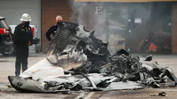 Los Angeles City firefighters extinguished the burning wreckage from a fatal plane crash just west of Van Nuys Airport on Friday.