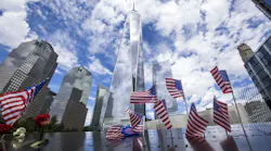 The Freedom Tower at One World Trade Center rises in the background of the 9/11 Memorial in lower Manhattan in New York City.