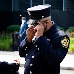 Detroit firefighter Timothy Carter II wipes his eyes at the end of a memorial service for Sgt. Sivad Johnson outside the Detroit Public Safety Headquarters on Monday. Johnson died while trying to rescue two girls who were drowning Aug. 21 in the Detroit River at the Belle Isle Beach.