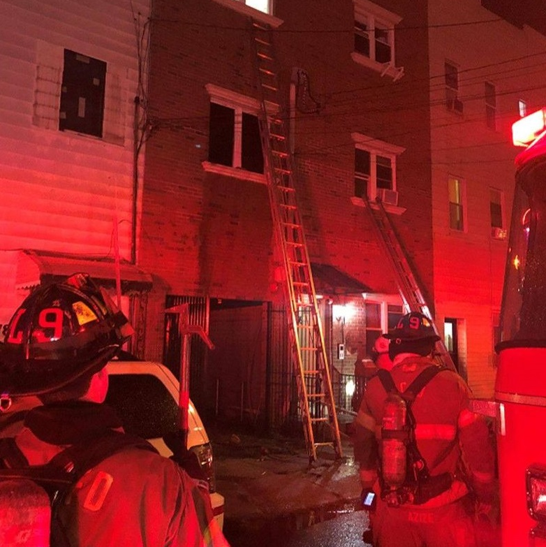 Jersey City, NJ, firefighters rescued a woman who was trapped on the top floor of a burning three-story residential building Tuesday.