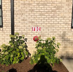 Most plan sets will include a site plan which will detail landscaping; here we see the FDC for our example building. Is this landscaping part of the submitted plans? Did someone overlook this in the approval process, or during acceptance testing of the installed systems? Or did the building owner pull a “fast one” after receiving a certificate of occupancy? It’s out of the hands of the plans reviewer and the firefighter now, and resolution will require a fire inspector willing to educate the occupants on why this area must be kept clear. How big will these bushes be next year, or the year after? Most plan sets will include a site plan which will detail landscaping; here we see the FDC for our example building. Is this landscaping part of the submitted plans? Did someone overlook this in the approval process, or during acceptance testing of the installed systems? Or did the building owner pull a “fast one” after receiving a certificate of occupancy? It’s out of the hands of the plans reviewer and the firefighter now, and resolution will require a fire inspector willing to educate the occupants on why this area must be kept clear. How big will these bushes be next year, or the year after?