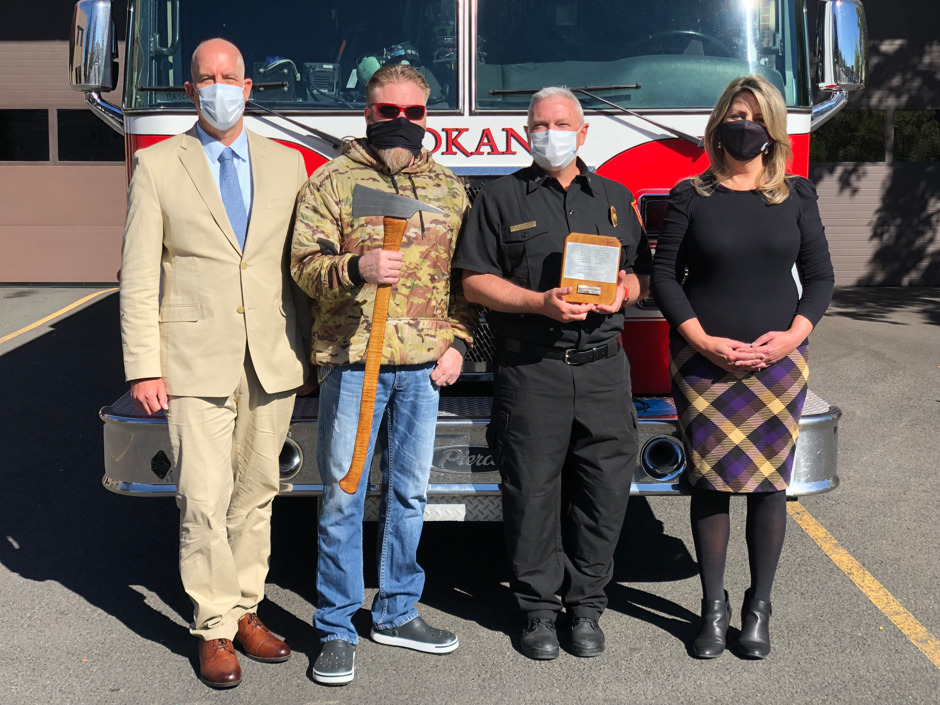 Pictured from left: Steve Danyluk, Boone Cutler, Spokane Fire Department Chief Brian Schaeffer, and Spokane Mayor Nadine Woodward.