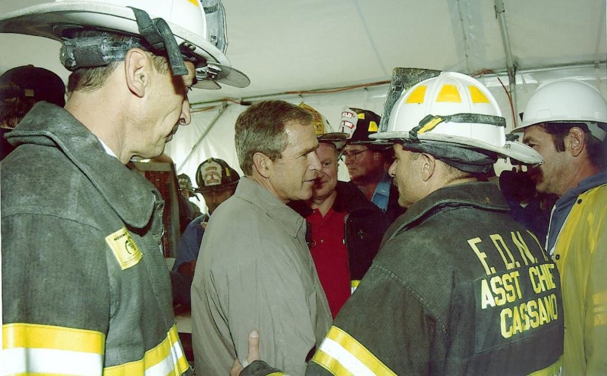 Daniel Nigro, who was FDNY chief of operations of 9/11 (left) and Sal Cassano, who was the citywide tour commander on 9/11, meet with President George W. Bush at Ground Zero.