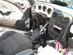 Figure 4. The interior of the two-door convertible shows not only frontal airbag deployment but significant bending of the steering wheel ring and total failure of the steering column mounting bracket. Figure 4. The interior of the two-door convertible shows not only frontal airbag deployment but significant bending of the steering wheel ring and total failure of the steering column mounting bracket.