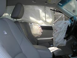 Perspective from the passenger&rsquo;s side of the sedan shows the three deployed airbags, the blood splatters and the lack of passenger-side airbag deployment.