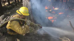 A U.S. Forest Service engine crew member sprays down flames on the northwest flank of the August Complex Fire, above Ruth Valley, CA, on Sept. 22.