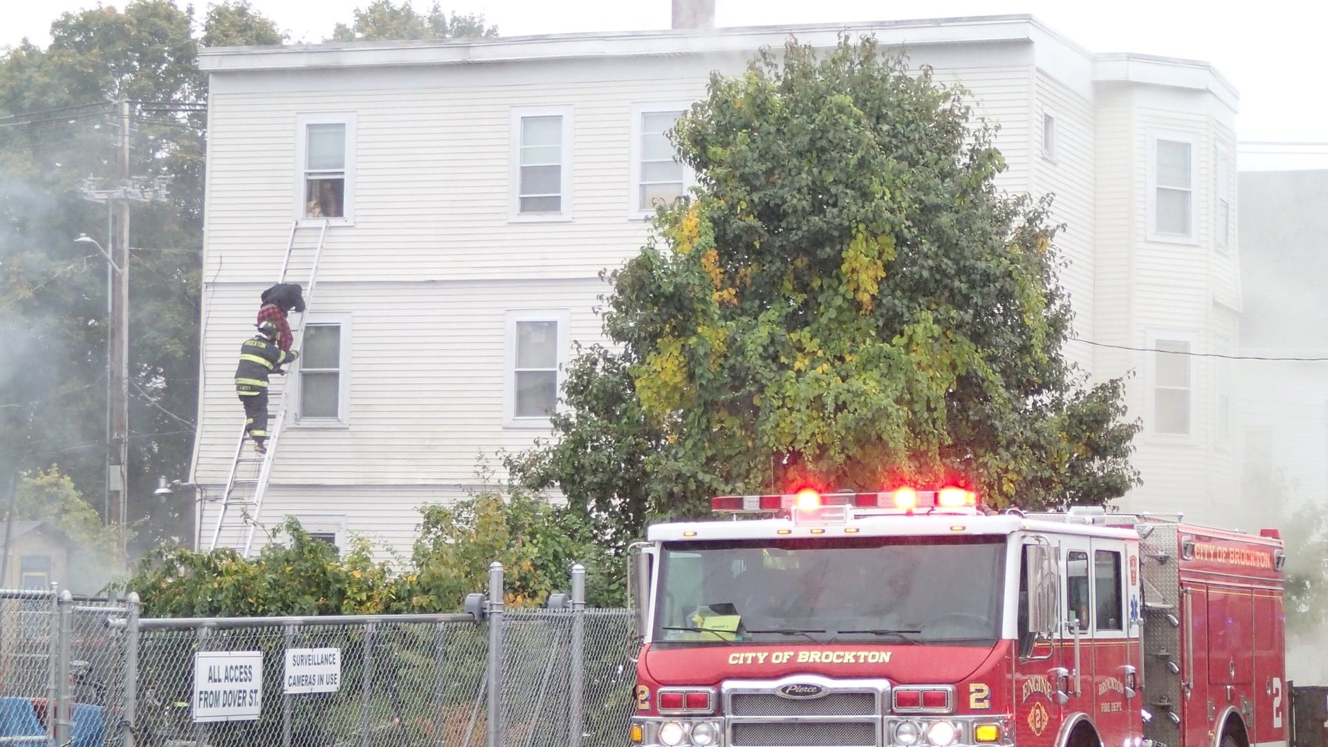 Brockton, MA, firefighters rescued a woman and a three children from a two-alarm blaze Tuesday.