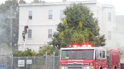 Brockton, MA, firefighters rescued a woman and a three children from a two-alarm blaze Tuesday.