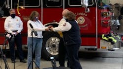 Jill Halsey (left) receives her father's retirement badge from members of the Clayton, MO, Fire Department. Halsey's father was the city's first fire marshal, and the badge was lost years ago in Florida. Jill Halsey (left) receives her father's retirement badge from members of the Clayton, MO, Fire Department. Halsey's father was the city's first fire marshal, and the badge was lost years ago in Florida.