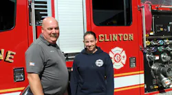 Kacie Ortiz, Clinton's newest firefighter, poses with Fire Chief Michael Lutes as she started as the first female to join the ranks.