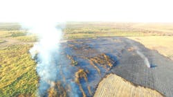 A photograph from an Artesia, NM, Police Department drone shows a major brush fire burning in the old Lake McMillan bed on Oct. 16. Seven Eddy County volunteer fire departments responded to the blaze along with Eddy County Fire Services.