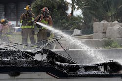 Firefighters work to put out a fire aboard a boat on the New River in Fort Lauderdale, FL, on Thursday that injured at least 13 people. Firefighters work to put out a fire aboard a boat on the New River in Fort Lauderdale, FL, on Thursday that injured at least 13 people.