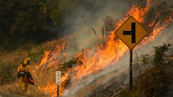A firefighter uses a drip torch during a backfire operation Sept. 29 during the Glass Fire along Silverado Trail in Calistoga, CA. A firefighter uses a drip torch during a backfire operation Sept. 29 during the Glass Fire along Silverado Trail in Calistoga, CA.