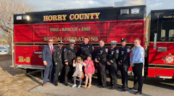 Horry County, SC, volunteer firefighter and Myrtle Beach Police Officer Jacob Hancher (center).