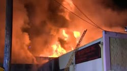 Los Angeles firefighters battle a massive fire that spread to two buildings in the city's Garment District on Tuesday. Los Angeles firefighters battle a massive fire that spread to two buildings in the city's Garment District on Tuesday.