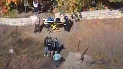 Two juveniles helped Minneapolis firefighters rescue a person who fell down a Mississippi River bluff Wednesday.