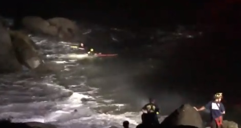 San Francisco firefighters rescue a person from the rocks in the water around the Presidio early Wednesday.
