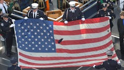 A U.S. flag recovered from the 9/11 attacks is displayed by New York City police officers and firefighters during the ceremony marking the 10th anniversary of the terrorist attack in 2011. A U.S. flag recovered from the 9/11 attacks is displayed by New York City police officers and firefighters during the ceremony marking the 10th anniversary of the terrorist attack in 2011.