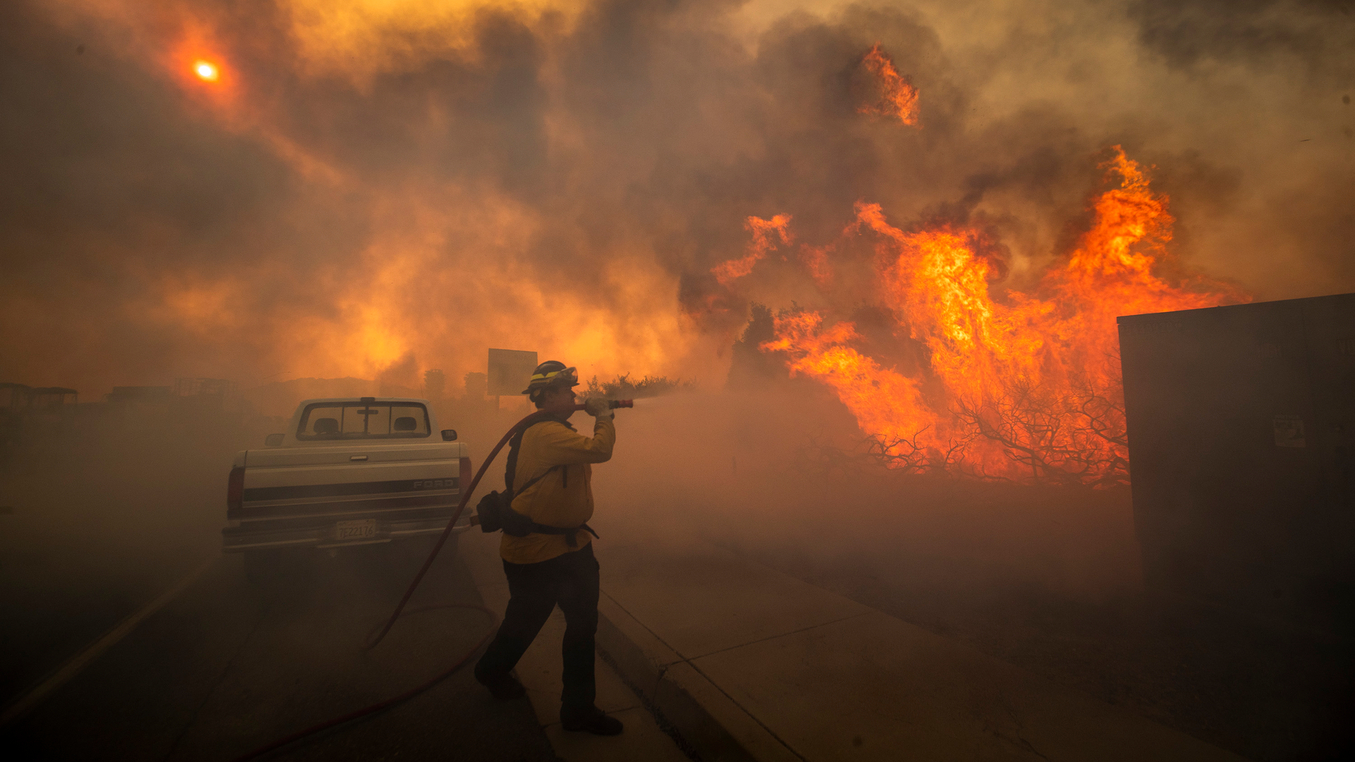 Firefighter Raymond Vasquez braves tall flames as he fights the advancing Silverado Fire, fueled by Santa Ana winds, at the 241 toll road and Portola Parkway in Irvine, CA, on Monday.