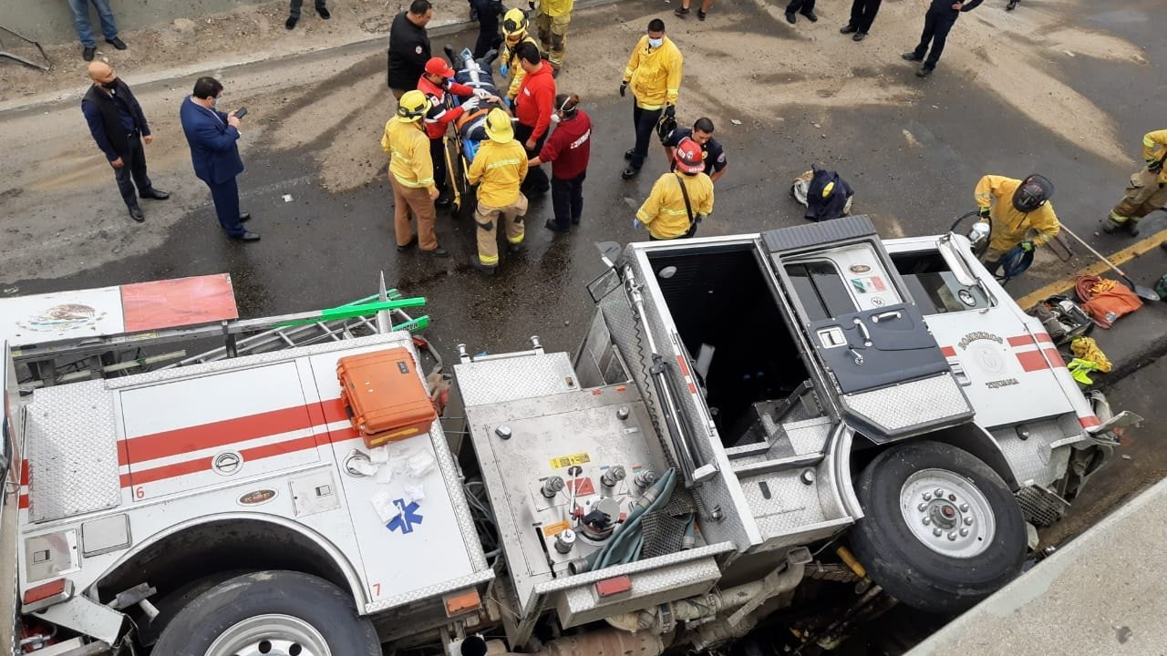 Three firefighters were injured when their apparatus plunged 20-feet off a bridge south of the California-Mexico border in Tijuana on Friday.