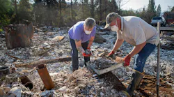 Upper McKenzie, OR, Fire Chief Christiana Rainbow Plews (left) works with Clayton Canfield as they sift through the debris of her home this week in Vida.