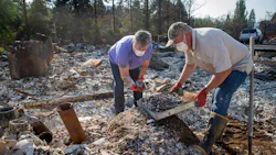 Upper McKenzie, OR, Fire Chief Christiana Rainbow Plews (left) works with Clayton Canfield as they sift through the debris of her home this week in Vida.