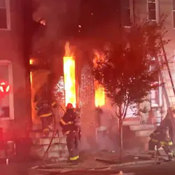 Two Baltimore City firefighters were injured during a blaze that broke out at a two-story rowhouse late Friday.