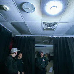 Fogelsville, PA, Volunteer Fire Company live-in volunteer firefighters, from left, Jake Serfass, Jake Gallich and Nick Bosga stand under a strobe light during a test to show what happens when a call comes in. The fire company is employing an approach to attracting and retaining new blood by offering free rent at the firehouse in exchange for 40 hours of volunteer fire service. Fogelsville, PA, Volunteer Fire Company live-in volunteer firefighters, from left, Jake Serfass, Jake Gallich and Nick Bosga stand under a strobe light during a test to show what happens when a call comes in. The fire company is employing an approach to attracting and retaining new blood by offering free rent at the firehouse in exchange for 40 hours of volunteer fire service.