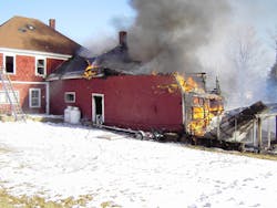 Although a portion of this dwelling was heavily involved in fire, proper placement of personnel with their hoseline protected the larger section of the building.