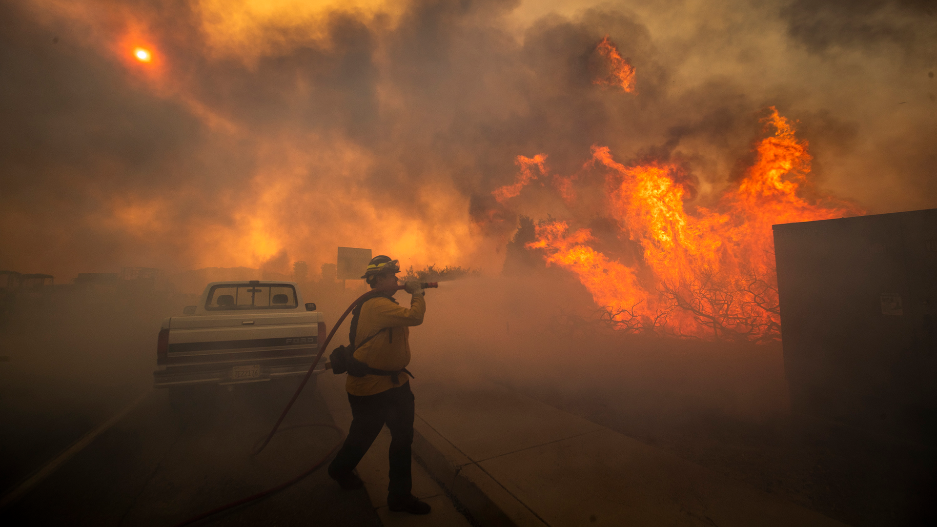 Firefighter Raymond Vasquez braves tall flames as he fights the advancing Silverado Fire in Irvine, CA, on Oct. 26, 2020.