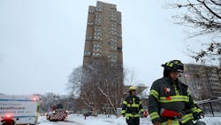 Minneapolis firefighters leave the scene of a fatal fire at a high-rise apartment building in 2019.