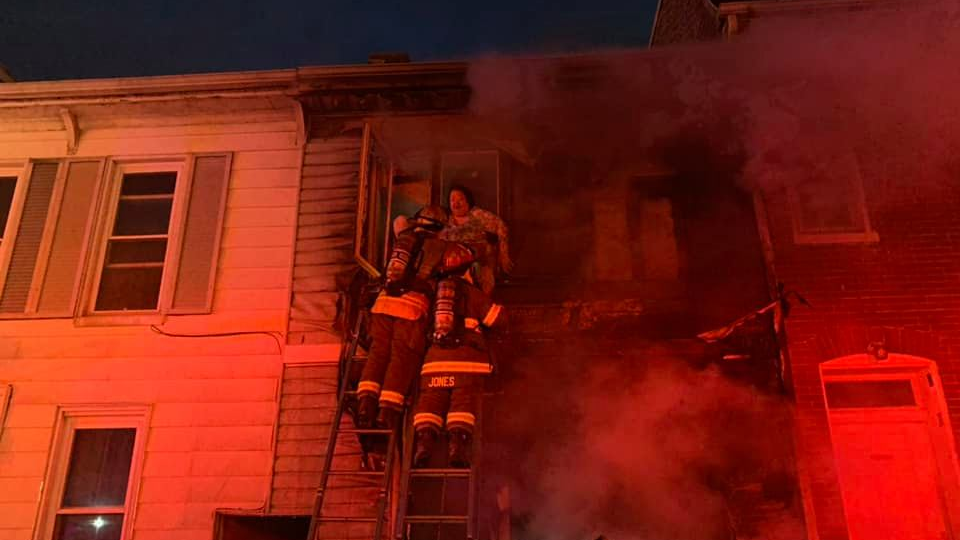 York City, PA, firefighters rescued two people and a dog who were trapped after two homes caught fire early Monday.