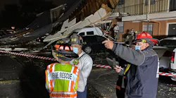 Arlington, TX, firefighters survey the damage done by a tornado and severe thunderstorms late Tuesday.