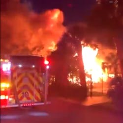 Multiple departments battled a three-alarm fire that destroyed two homes in Hudson and sent a person to the hospital with severe burns late Sunday.