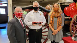 Fire Chief Michael Stanley (center) was presented with the Firefighter Hero Award by Oshkosh City Manager Mark Rohloff, and Jennifer Skolaski, who consulted with Chief Stanley on a falls prevention initiative and who nominated him for the award.