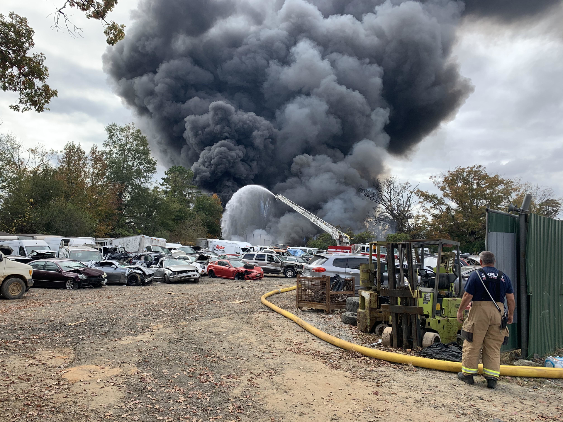 Firefighters work to extinguish a fire at Auto Parts U Pull & Scrap Metal in Shelby on Saturday.