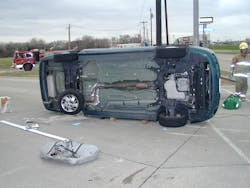 With the driver trapped, this vehicle was stabilized, and the damaged fuel tank was removed to minimize the hazard of the leaking fuel. Granular absorbent was applied to the spill. With the driver trapped, this vehicle was stabilized, and the damaged fuel tank was removed to minimize the hazard of the leaking fuel. Granular absorbent was applied to the spill.