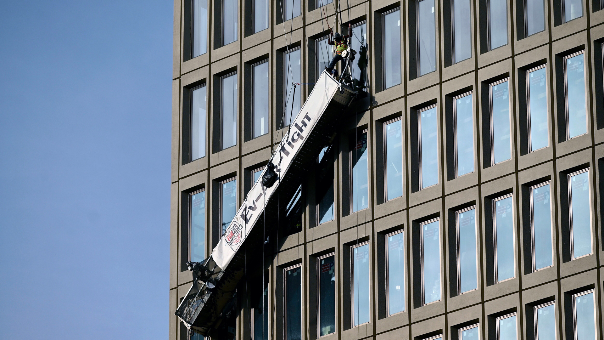 Two workers were rescued after they were trapped on a dangling scaffolding when an explosion rocked Baltimore Gas and Electric's downtown offices Wednesday.