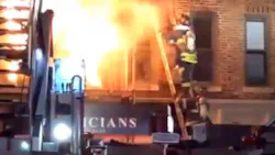 Raw video shows FDNY firefighters rescuing a person from the second-floor of a burning third-story, mixed use building in Brooklyn's Bay Ridge neighborhood late Monday.