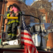 A Boston firefighter holds a girl after she was rescued from the top floor during a two-alarm residential blaze Wednesday.