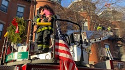 A Boston firefighter holds a girl after she was rescued from the top floor during a two-alarm residential blaze Wednesday. A Boston firefighter holds a girl after she was rescued from the top floor during a two-alarm residential blaze Wednesday.