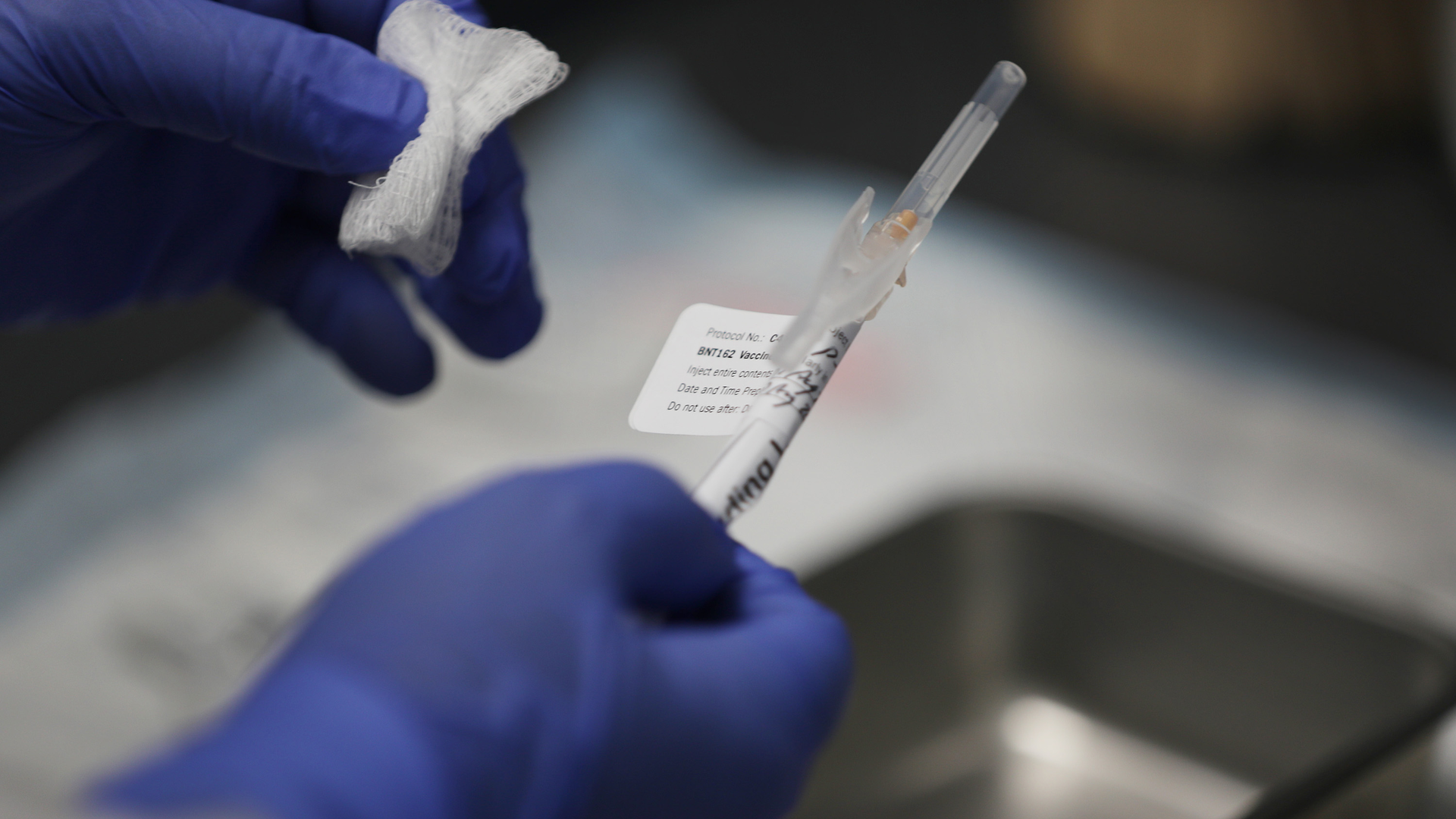 Jose Muniz prepares a COVID-19 vaccination at Research Centers of America in August in Hollywood, FL.