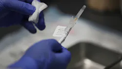 Jose Muniz prepares a COVID-19 vaccination at Research Centers of America in August in Hollywood, FL.