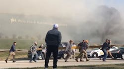 Dozens of people help pull a hoseline across a road during a massive commercial blaze in Campbellsville, KY, on Dec. 2 after a firefighter at the scene asked for help. Dozens of people help pull a hoseline across a road during a massive commercial blaze in Campbellsville, KY, on Dec. 2 after a firefighter at the scene asked for help.