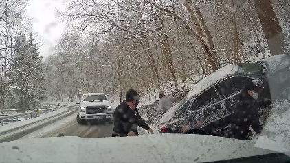 Two Collier Township, PA, EMS workers at an accident scene scramble out of the way of a pickup truck after it lost control and slammed into an emergency vehicle Wednesday.